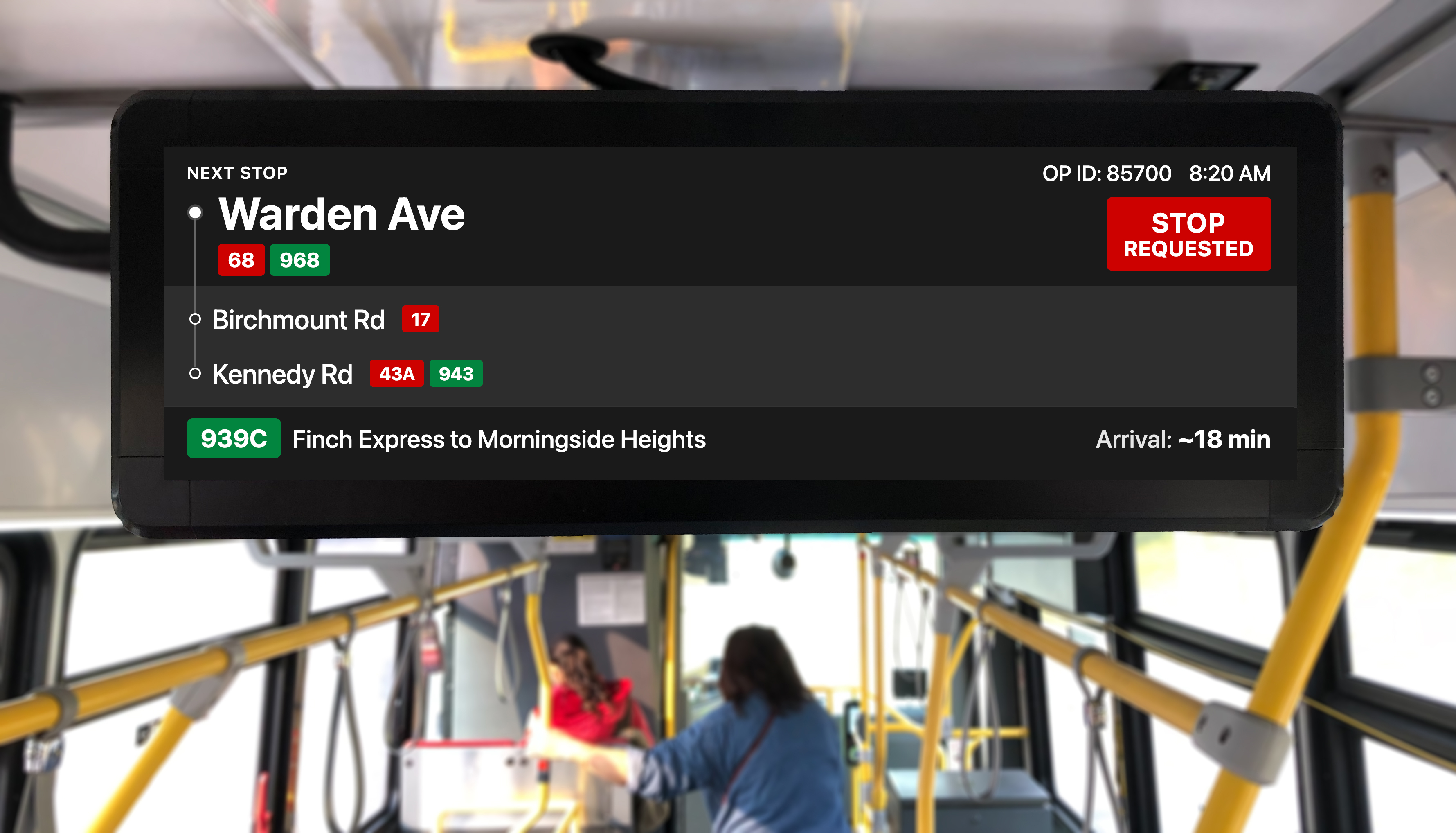 Wide-angle photo of new TTC bus interior showing the LCD passenger information display mounted above the front windows